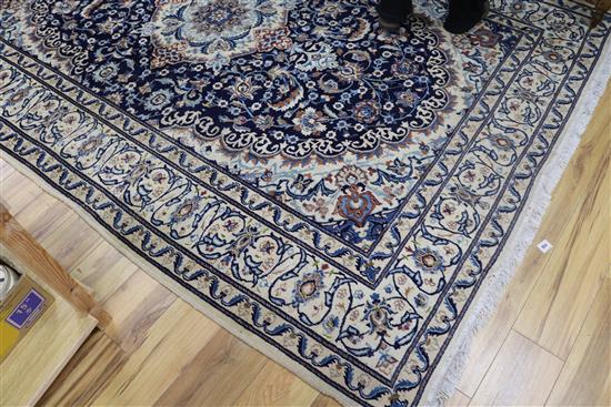 A Nain silk inlaid carpet, 295cm x 200cm.